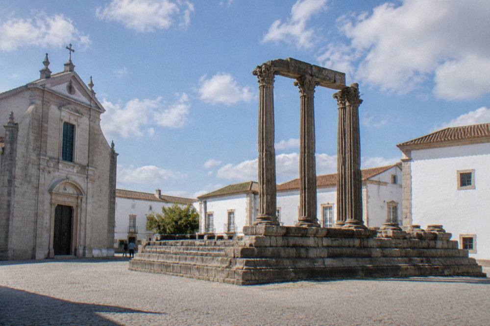 The Roman temple with columns standing on a platform in a square in Évora