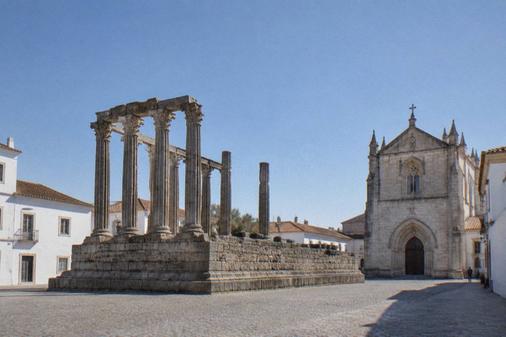 The Roman temple of Évora standing on its stone platform beside the cathedral