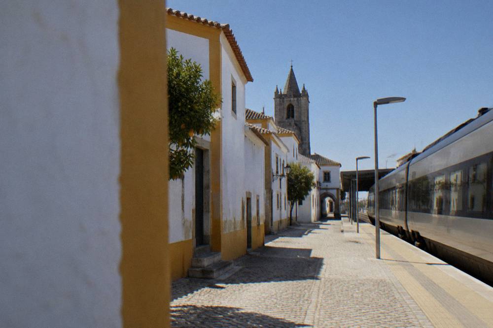 An Intercidades train arriving at Évora station under a clear sky