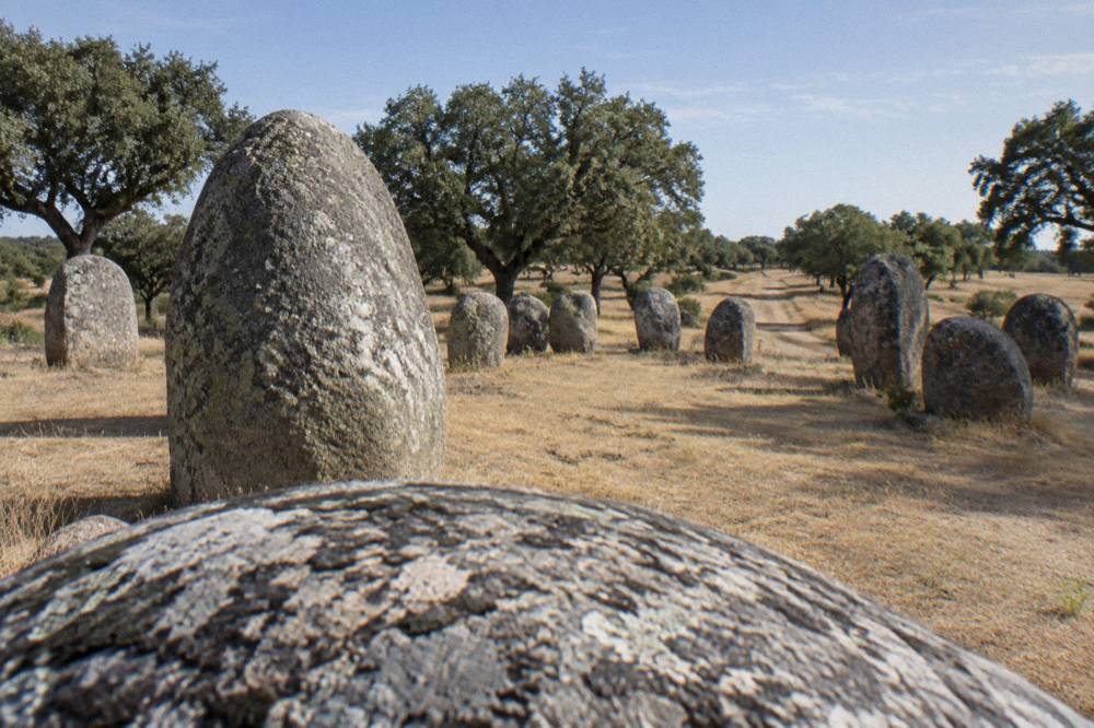 Standing stones of the Almendres Cromlech on the open Alentejo plain near Évora