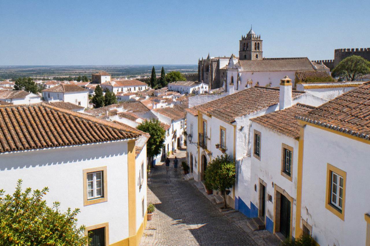 The walled historic centre of Évora seen from a distance under a clear Alentejo sky