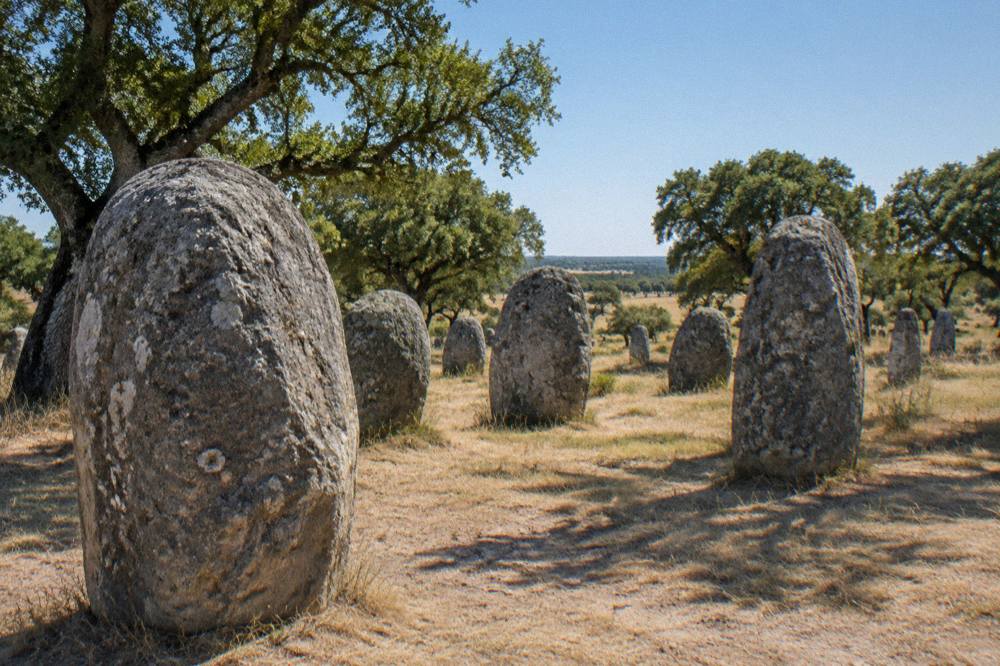 Standing stones of the Almendres cromlech in rolling open countryside near Évora