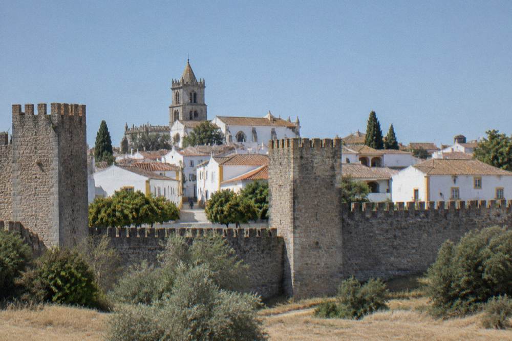 The stone walls and towers of Évora old town seen from outside the city