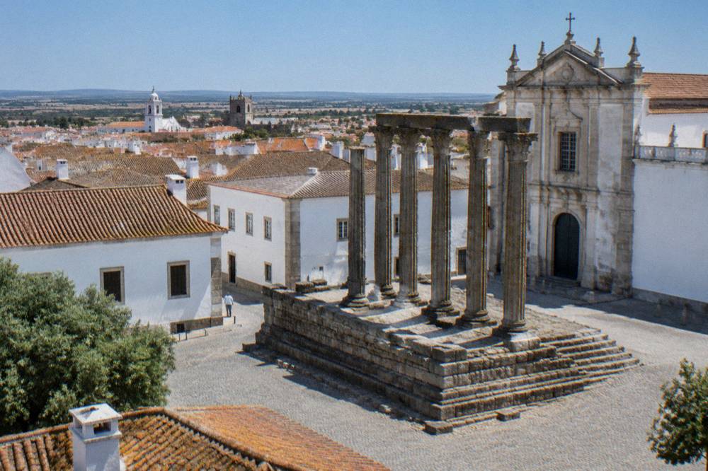 The Roman temple columns of Évora rising above the old town rooftops