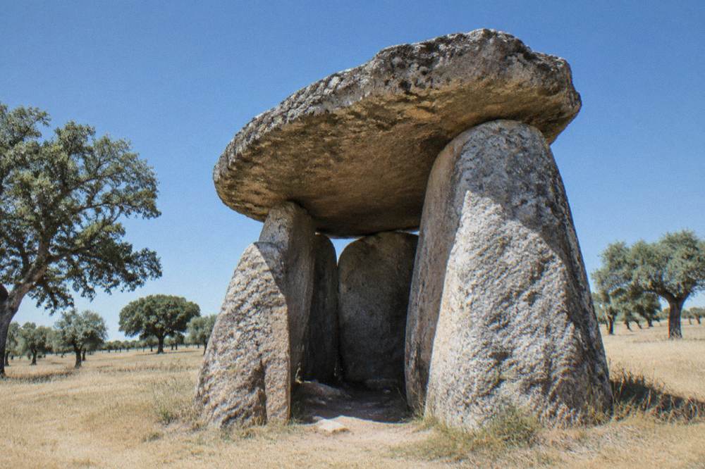The huge stone slabs of a chambered dolmen tomb standing in open Alentejo countryside