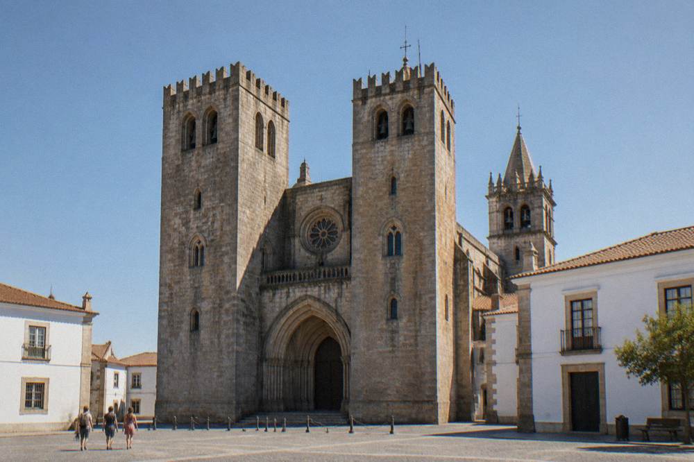 Interior of Évora cathedral with stone arches and soft light from high windows