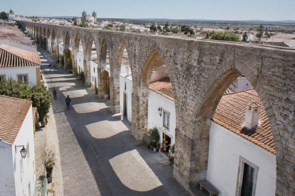 Houses built into the stone arches of the Água de Prata aqueduct on the edge of Évora