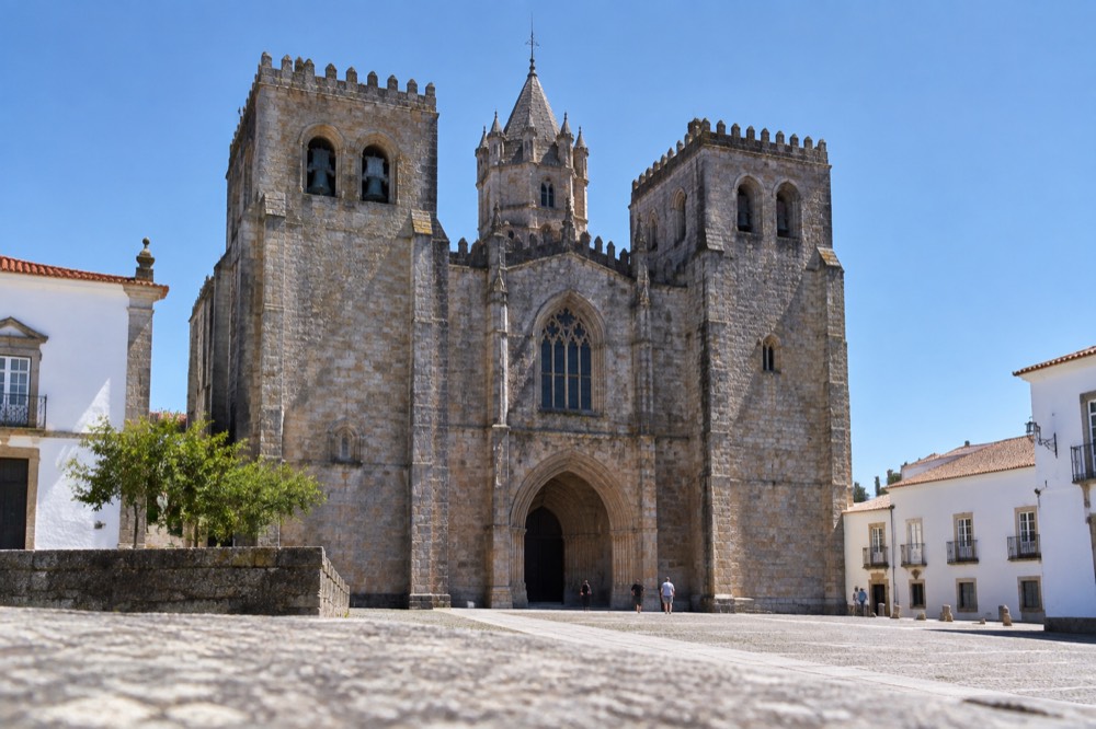 The Gothic interior of Évora cathedral with stone vaults and warm light