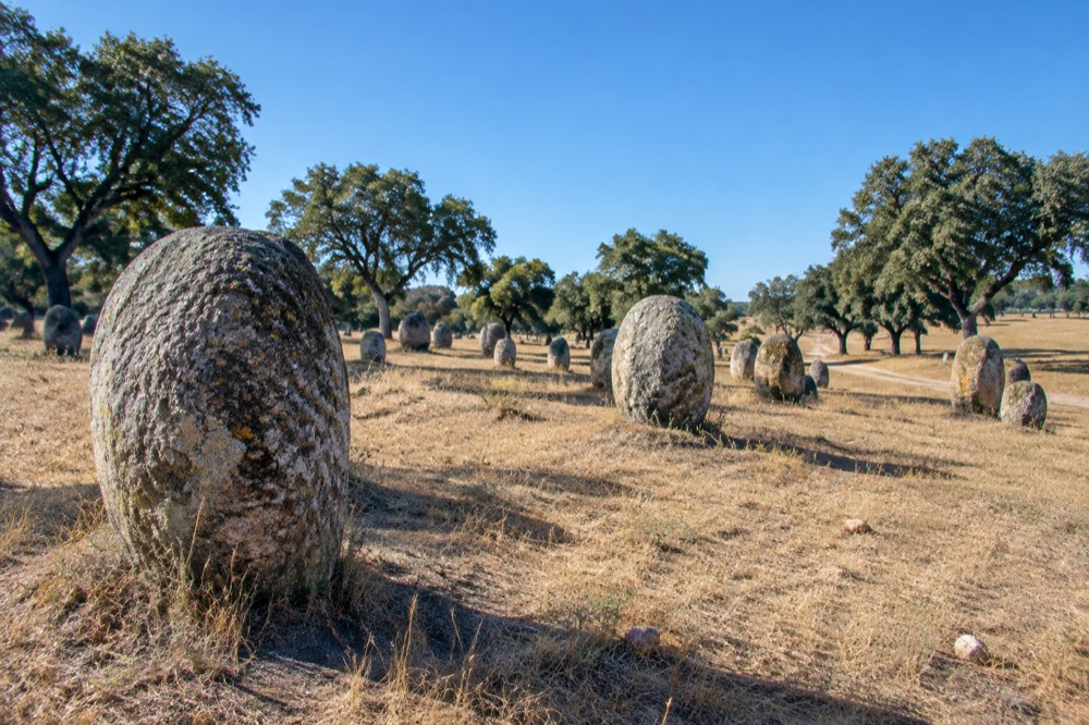 Ancient standing stones of the Almendres cromlech on a grey overcast day in the Alentejo countryside