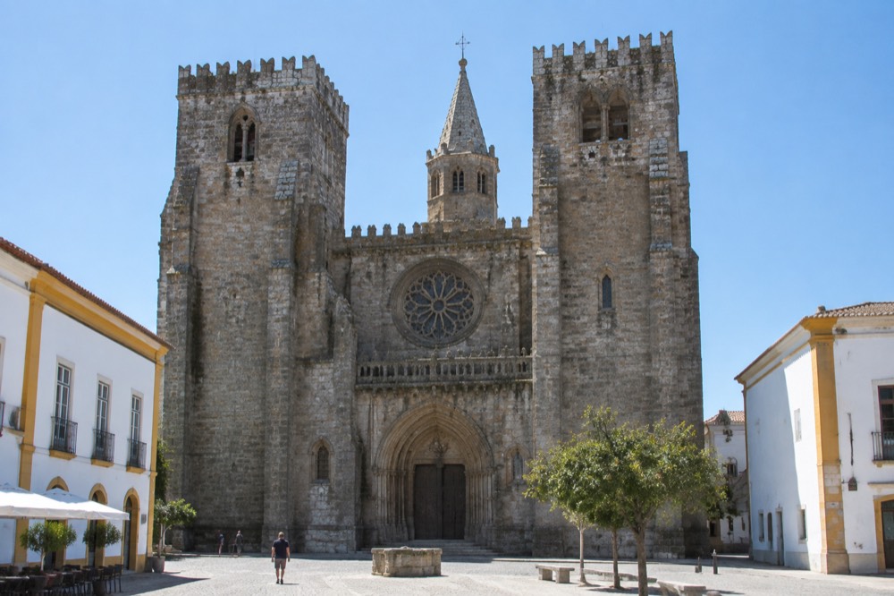 The Gothic cathedral of Évora with its rose window seen from the square below